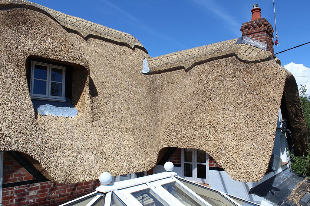 Dormer window of cottage thatched in water reed