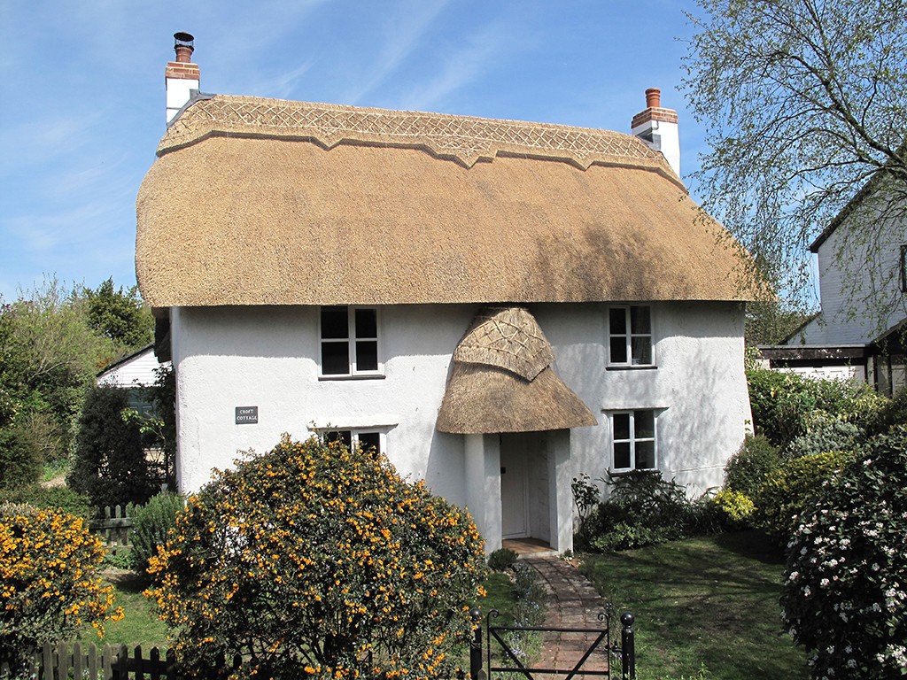 Cottage thatched in water reed with straight and diamond turnover ridge